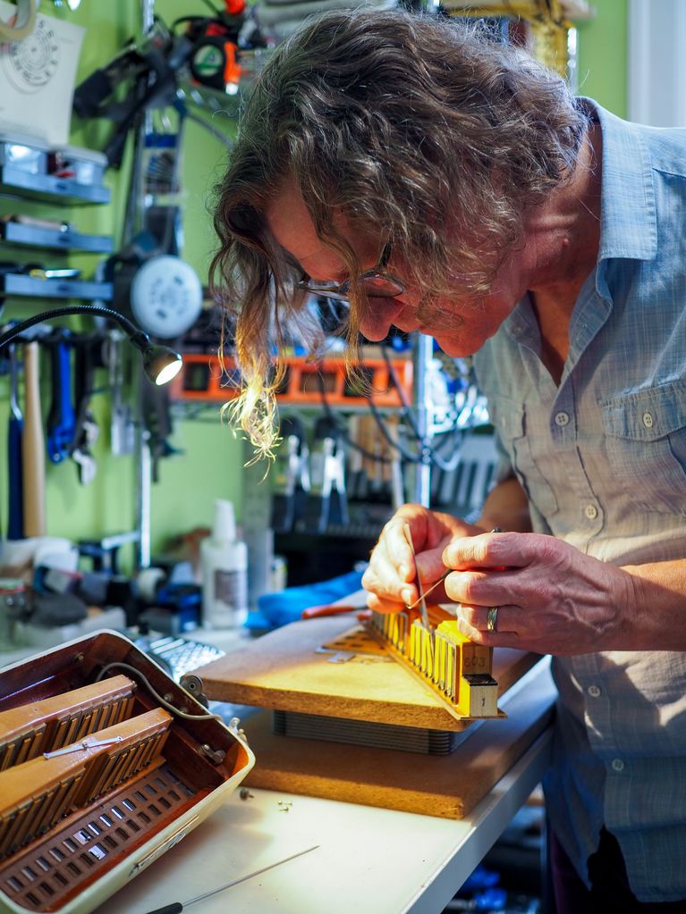 David Beer, Squeezebox Surgeon, repairing an accordion in their shop.